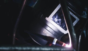 close up welder wearing welding helmet
