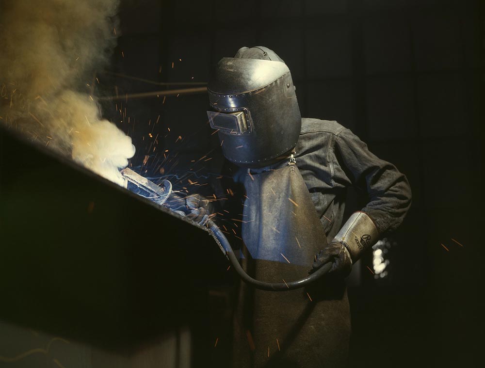 welder with helmet at work