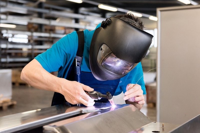 a welder wearing a welding helmet