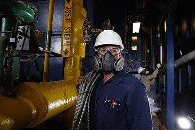 a man wearing a welding respirator
